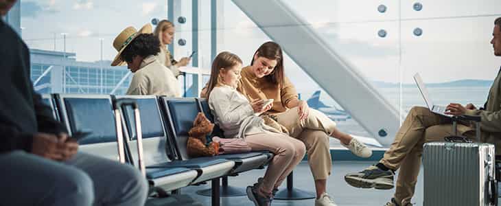 Family looking at a book in airport